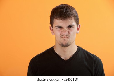 Latino Male With Messy Hair And Wrinkled Nose