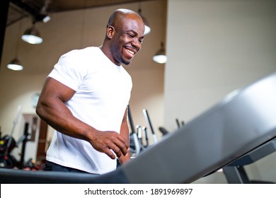 latino man in sportswear running on treadmill at gym