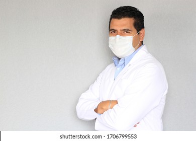 Latino Medical Man With Protective Gown And Mask To Prevent Covid-19