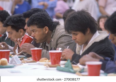 Latino Men Eating Christmas Dinner At Homeless Shelter, Los Angeles, California