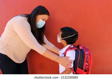 Latino Mom And Son Prepare To Go Back To School With A Backpack And Face Mask As Protection From Covid-19 In The New Normality Due To The Coronavirus Pandemic
