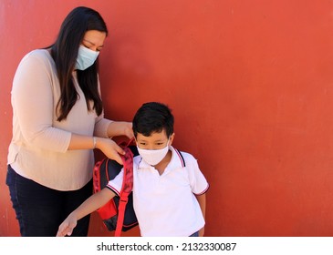 Latino Mom And Son Prepare To Go Back To School With A Backpack And Face Mask As Protection From Covid-19 In The New Normality Due To The Coronavirus Pandemic
