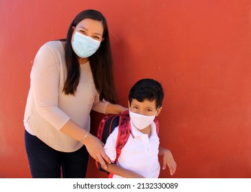 Latino Mom And Son Prepare To Go Back To School With A Backpack And Face Mask As Protection From Covid-19 In The New Normality Due To The Coronavirus Pandemic
