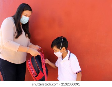 Latino Mom And Son Prepare To Go Back To School With A Backpack And Face Mask As Protection From Covid-19 In The New Normality Due To The Coronavirus Pandemic
