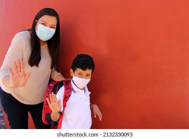 Latino Mom And Son Prepare To Go Back To School With A Backpack And Face Mask As Protection From Covid-19 In The New Normality Due To The Coronavirus Pandemic
