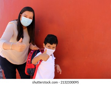 Latino Mom And Son Prepare To Go Back To School With A Backpack And Face Mask As Protection From Covid-19 In The New Normality Due To The Coronavirus Pandemic
