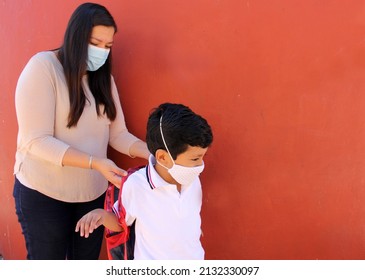 Latino Mom And Son Prepare To Go Back To School With A Backpack And Face Mask As Protection From Covid-19 In The New Normality Due To The Coronavirus Pandemic
