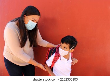 Latino Mom And Son Prepare To Go Back To School With A Backpack And Face Mask As Protection From Covid-19 In The New Normality Due To The Coronavirus Pandemic
