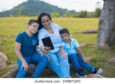 Latino Mom And Sons Sitting Taking A Selfie