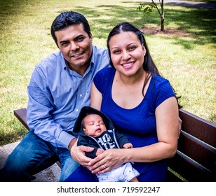 Latino parents with their newborn baby