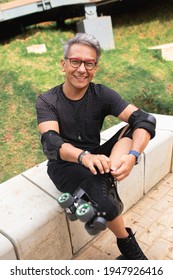 Latino Senior Man Putting On His Roller Skates