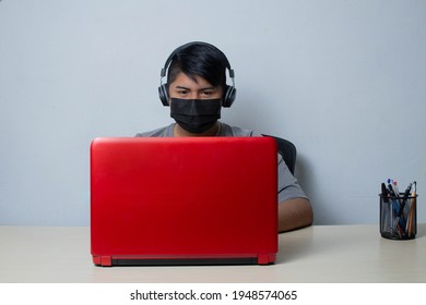 Latino Student Wearing Face Mask While Taking Online Class By Video Conference On Laptop For Homeschooling