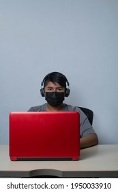 Latino Student Wearing Face Mask While Taking Online Class By Video Conference On Laptop For Homeschooling. Mexican Man