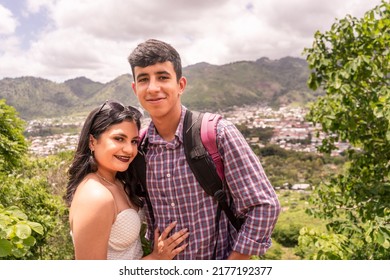 Latino Teen Couple Smiling And Having Fun On A Mountain