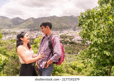 Latino Teen Couple Smiling And Having Fun On A Mountain