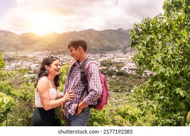 Latino Teen Couple Smiling And Having Fun On A Mountain