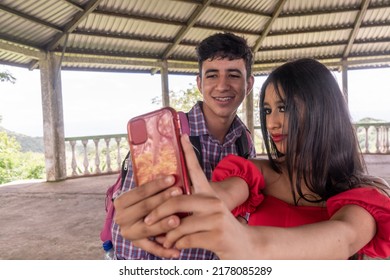 Latino Teen Couple Taking A Self Portrait In A Public Place