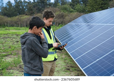 Latino Young Man Learning from a Student Engineer while Monitoring Solar Panels - Powered by Shutterstock