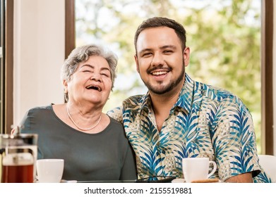 Latinos. The older mother and her adult son enjoy some time together at home.