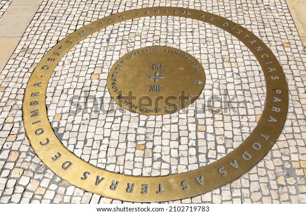 Latitude and Longitude marker. Kilometer zero point\
or Zero mile marker. Inscription: The distances to all the lands of\
Coimbra start from this landmark. Coimbra, Portugal - August 20,\
2019