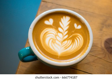 Latte art in a blue cup