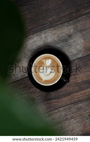Latte art coffee cup. Close up latte foam texture in cappuccino hot coffee cup with beautiful light and shadow, top view.