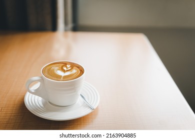 Latte Art Coffee Cup On White Plate Wood Table