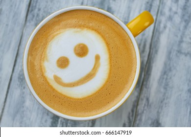Latte art smiley face. Top view of coffee. Surprising facts about caffeine.