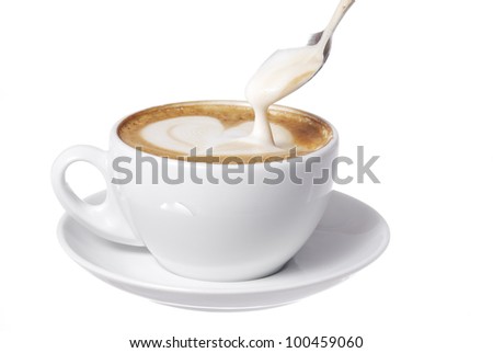Latte art and spoon. Focus on Spoon.