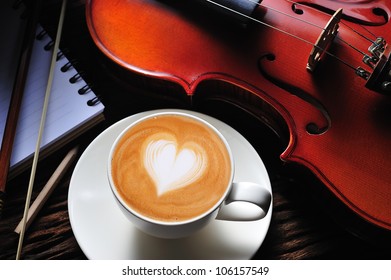 Latte Art And Violin On Wooden Table