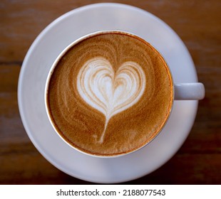 Latte Coffee With Beautiful Latte Art. Cup Of Coffee With Beautiful Latte Art On Wooden Table,cofee Time Concept.