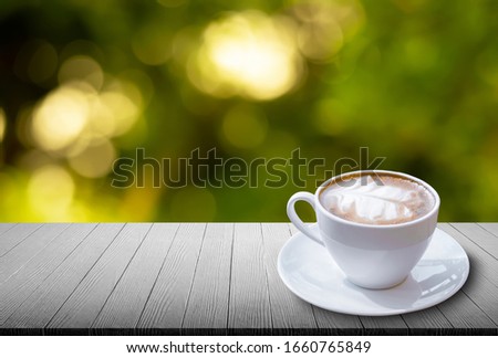 latte coffee cup background product for presentation on vintage empty aged white wood panel texture perspective template on the abstract green leaf background bokeh light for product display