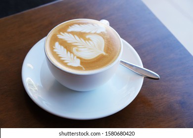 Latte coffee cup. A latte is a coffee drink made with espresso and steamed milk. The term as used in English is a shortened form of the Italian caffè latte, caffelatte or caffellatte.