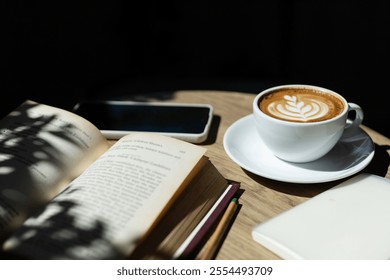 Latte coffee and reading book is open on wooden table with sunlight and diary for writing note, relax in the morning in cafe - Powered by Shutterstock