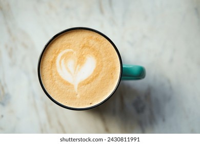 A latte with a heart in a mug on a marble table. - Powered by Shutterstock