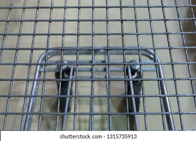 Lattice Empty Food Basket On Wheels. Concept Shopping In A Supermarket. Background Top View.