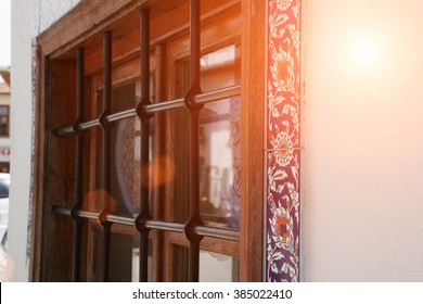 Lattice On Window Of An Old Stone House 