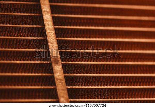Lattice texture of old rusty radiator with copy\
space. Background of automotive radiator close-up. Abstract artwork\
with auto part in macro.\
