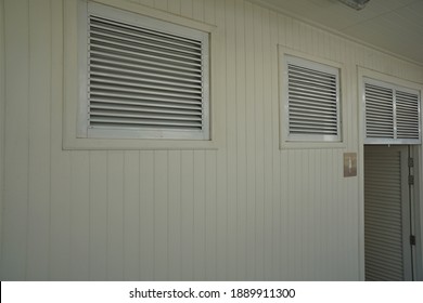 Lattice vents in the rectangular frame at the white wall.