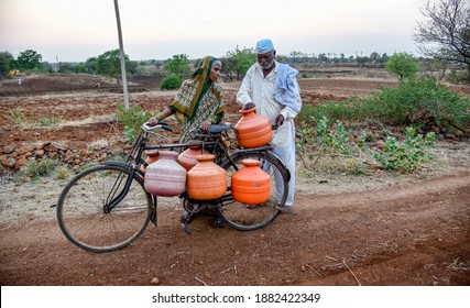 Latur, Maharashtra, India , April 07, 2016: Due To Severe Water Scarcity, Local Residents Fill Water In Huge Plastic Containers From A Water Tanker In Latur District, Maharashtra. India