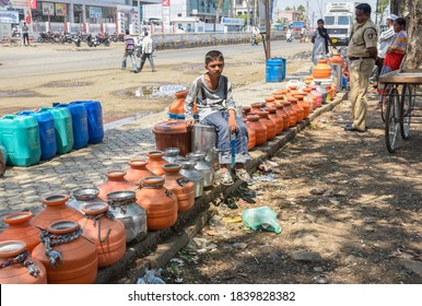 Latur, Maharashtra, India/April 07, 2016: Due To Severe Water Scarcity, Local Residents Fill Water In Huge Plastic Containers From A Water Tanker In Latur District, Maharashtra. India