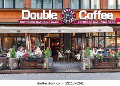 LATVIA, RIGA, SEPTEMBER, 2021 - People Have Lunch On The Open-air Veranda Of Double Coffee Cafe In Riga, Latvia.