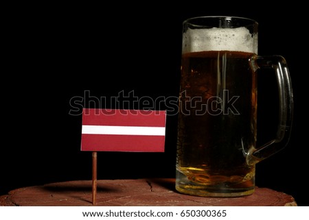 Latvian flag with beer mug isolated on black background