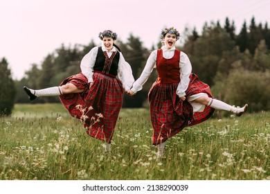 Latvian folk girls in traditional costume. Latvia summer. Symbolism of Latvia for Ligo holiday. Midsummer in Latvia. Traditional Latvian midsummer food. Celebration of Ligo in june decorating home wit