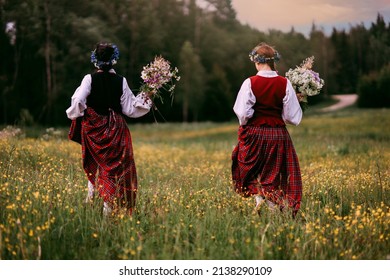 Latvian folk girls in traditional costume. Latvia summer. Symbolism of Latvia for Ligo holiday. Midsummer in Latvia. Traditional Latvian midsummer food. Celebration of Ligo in june decorating home wit
