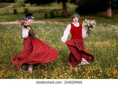 Latvian folk girls in traditional costume dancing. Summer Solstice. Midsummer. Summer. Dance.
