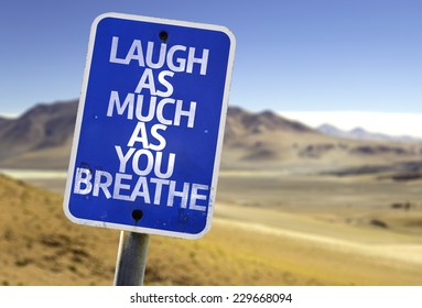Laugh As Much As You Breathe Sign With A Desert Background