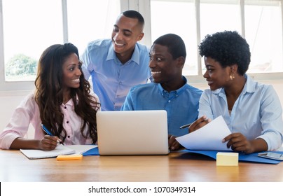 Laughing african american businessmen and businesswoman at office - Shutterstock ID 1070349314