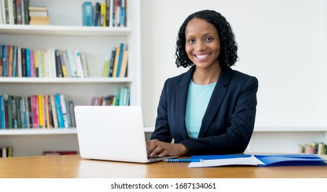 Laughing African American Businesswoman Working At Computer At Homeoffice To Stay At Home