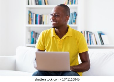 Laughing African American Mature Adult Man In Quarantine Working At Computer Indoors At Home